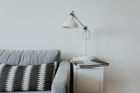 Minimalist study table with modern desk lamp and decorative setup by MAJISA Furniture.